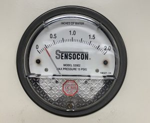 An up-close picture of the dial of a pressure meter